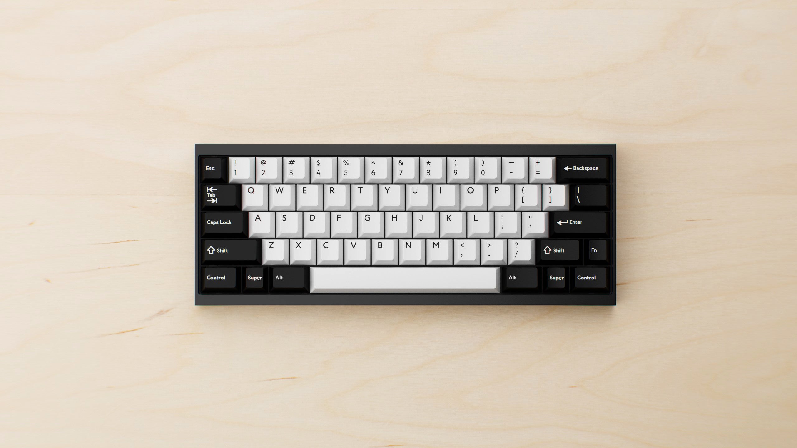Compact TOFU60 keyboard on a light wood desk