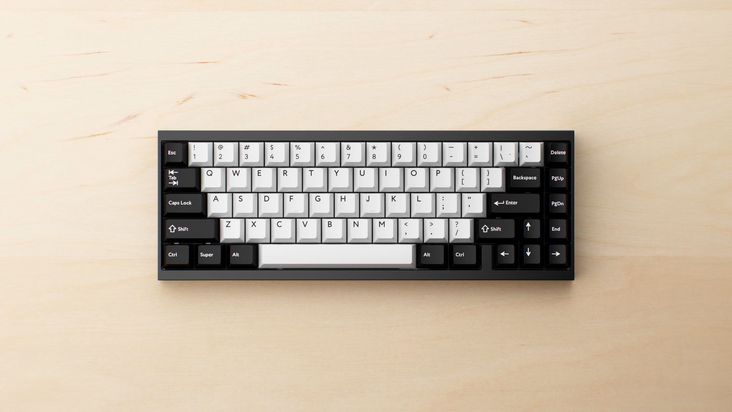 TOFU65 keyboard with dedicated arrow keys on a light wood desk